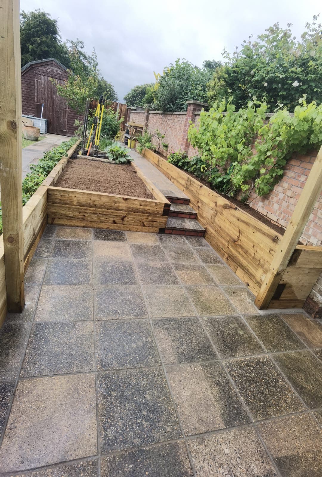 Patio installation Suffolk — Stone slab patio with raised beds and garden features